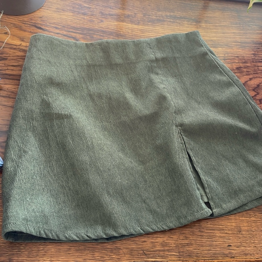 Dark green mini skirt with small slit
